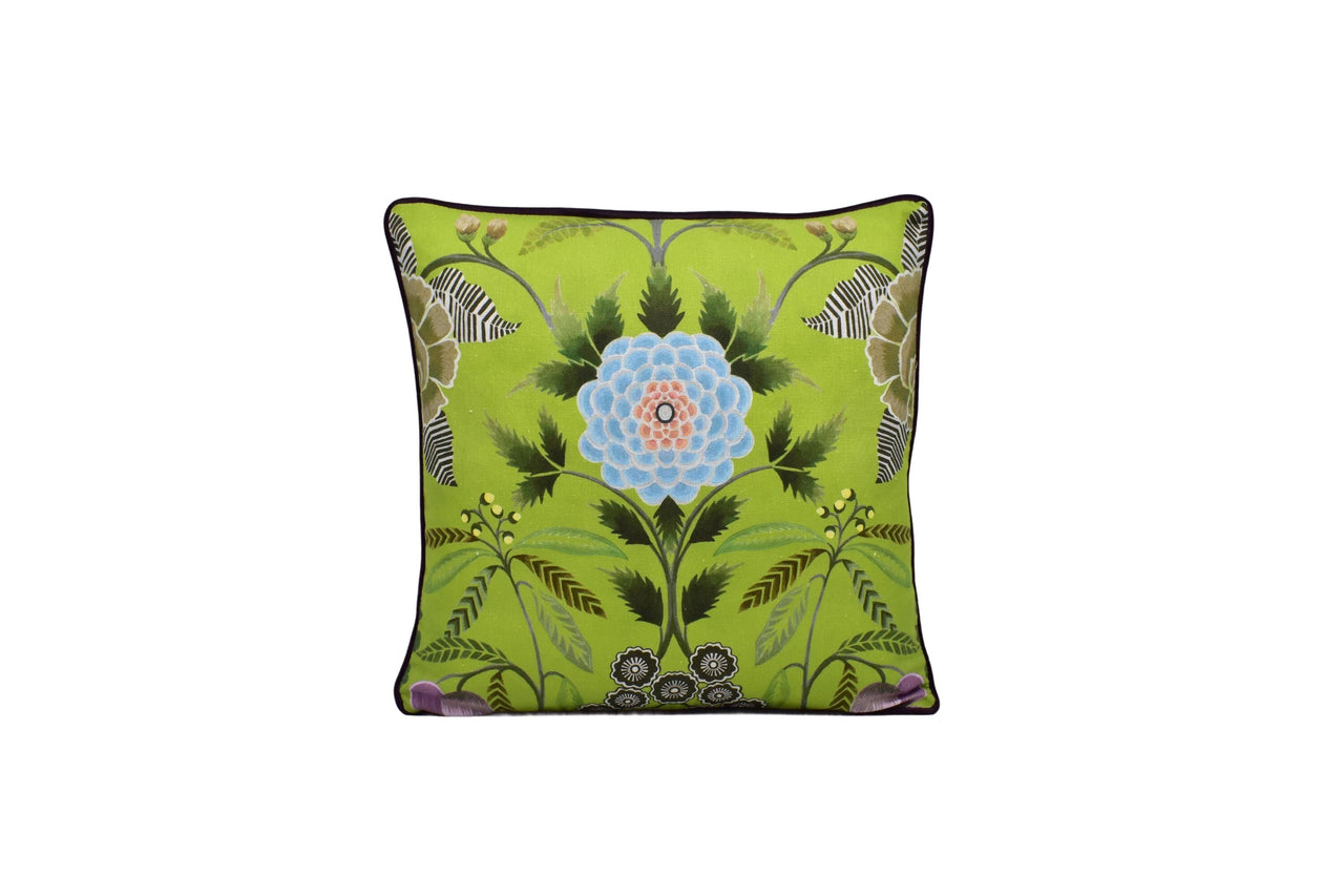 a green pillow with a blue flower on it