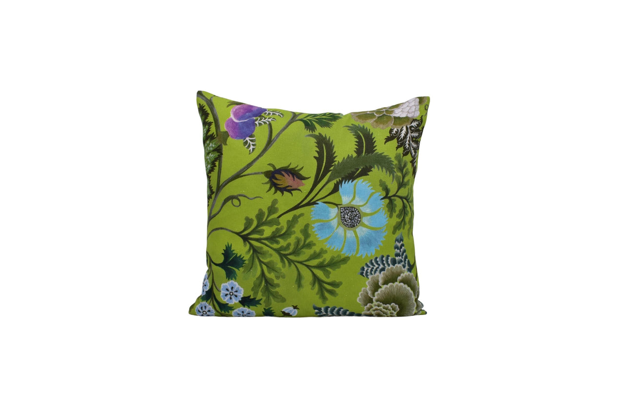 a green pillow with blue flowers on it