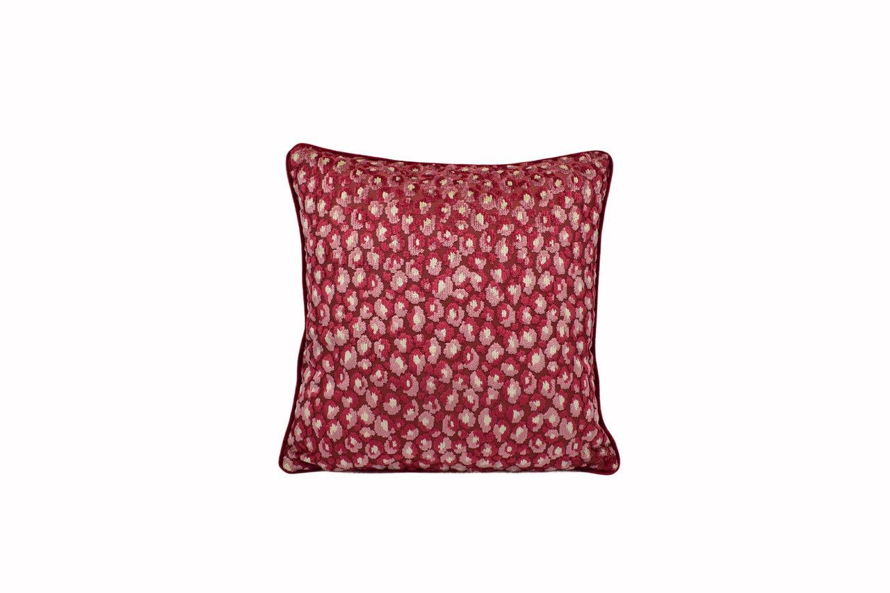 a red and white pillow on a white background