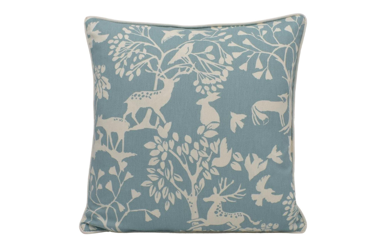 a blue and white pillow with deers on it