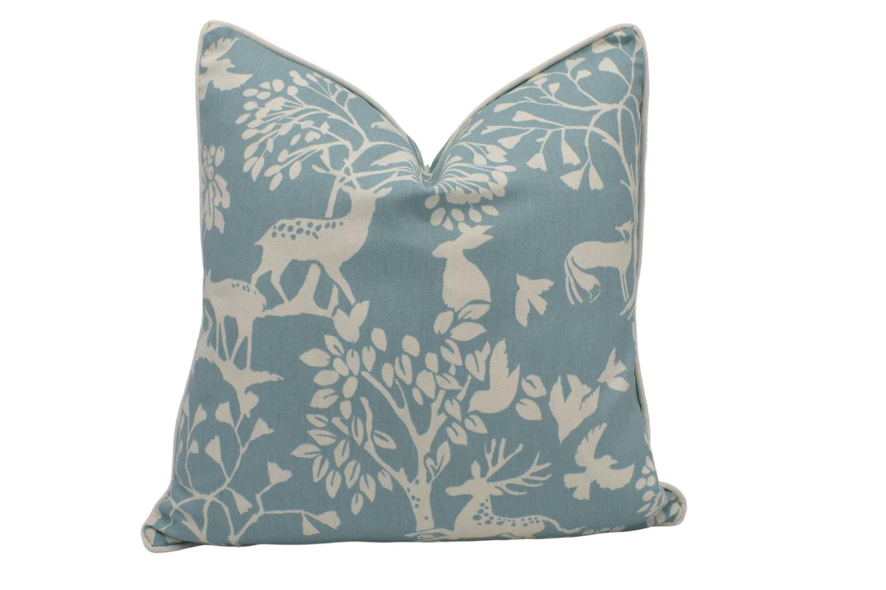 a blue and white pillow with animals on it