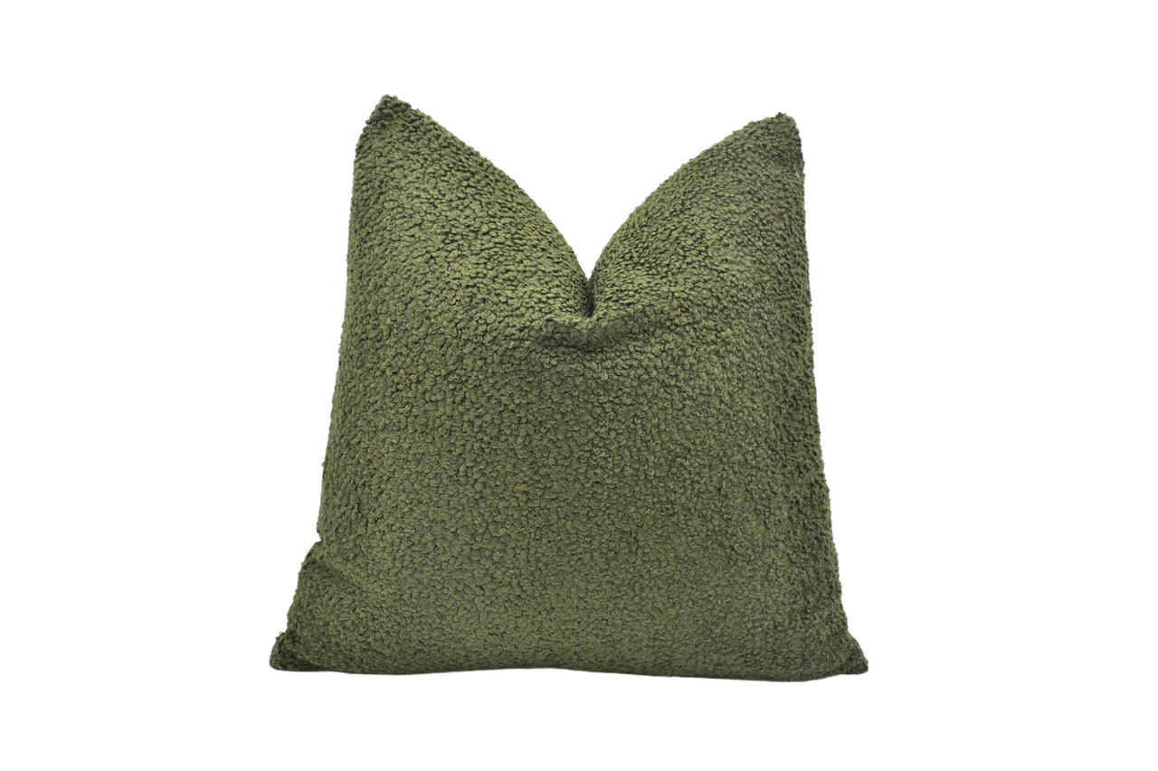 a green pillow on a white background