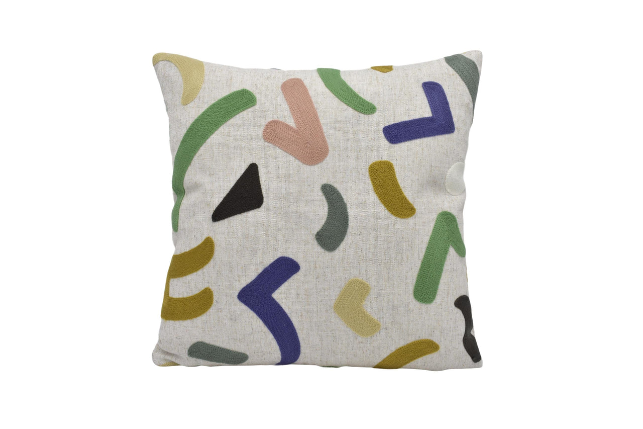 a white pillow with multicolored shapes on it