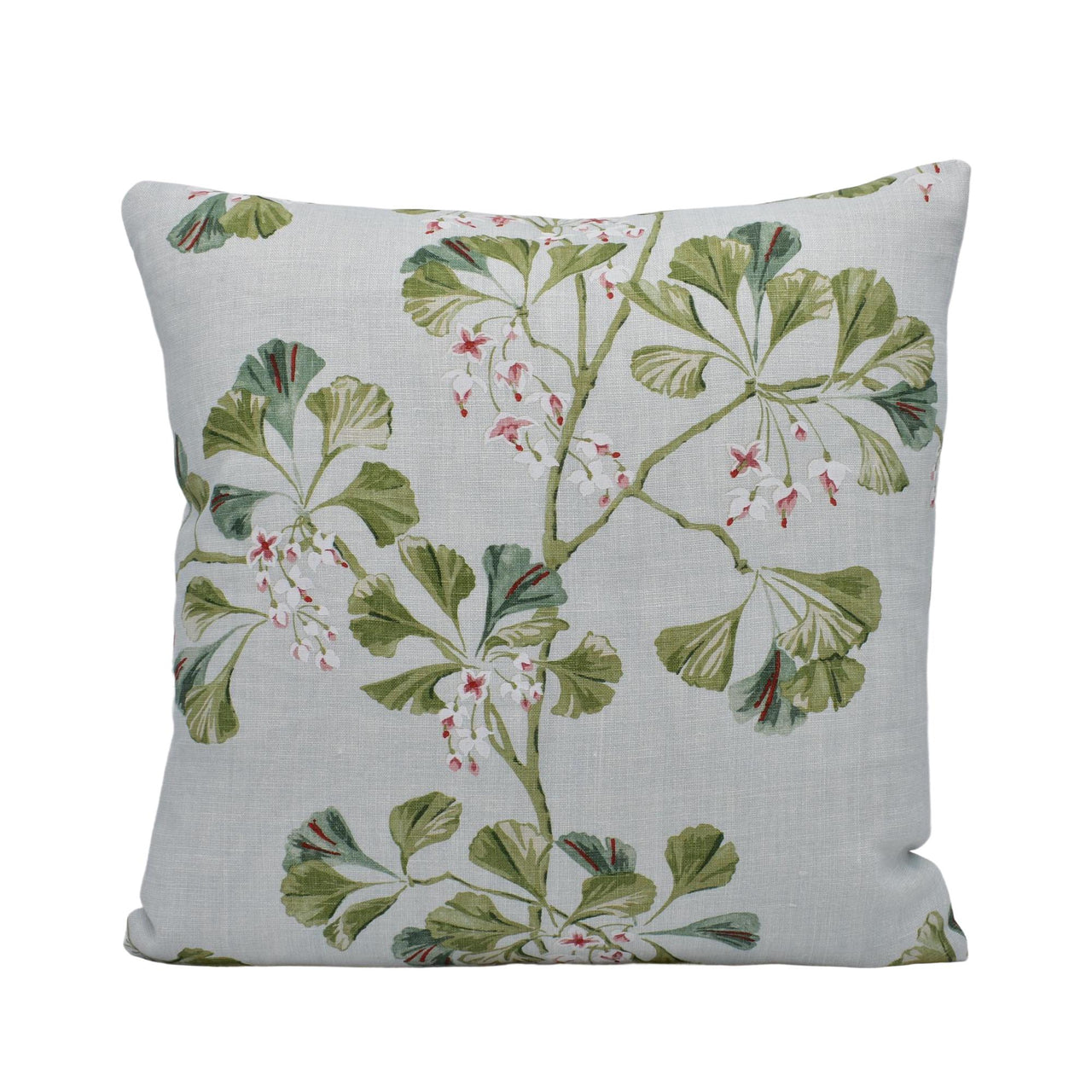 a white pillow with green leaves and berries on it