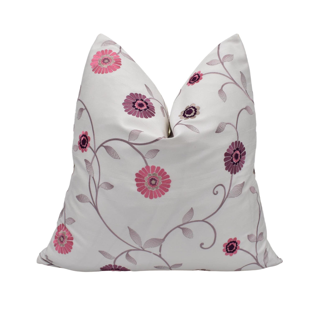 a white pillow with pink flowers on it