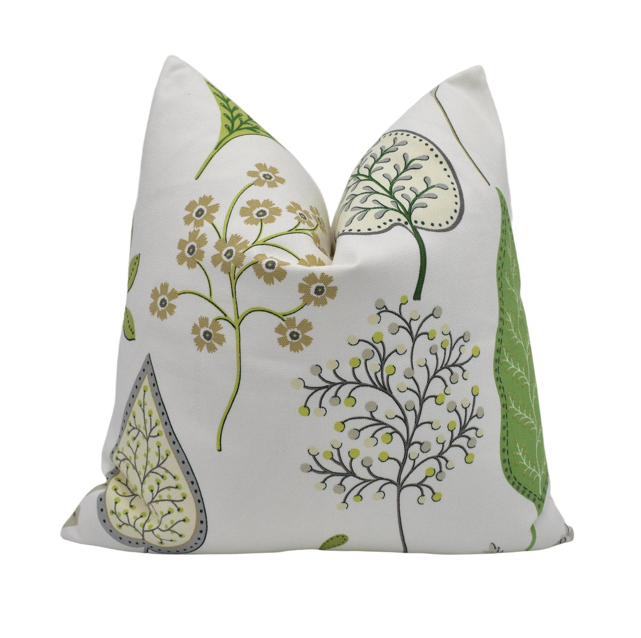 a white pillow with a green and yellow floral design