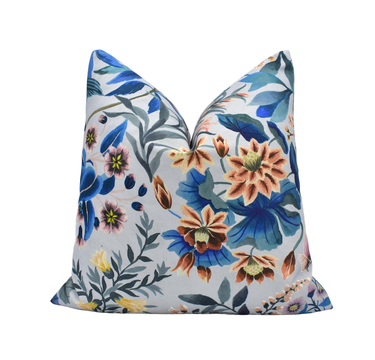 a white pillow with blue and orange flowers on it