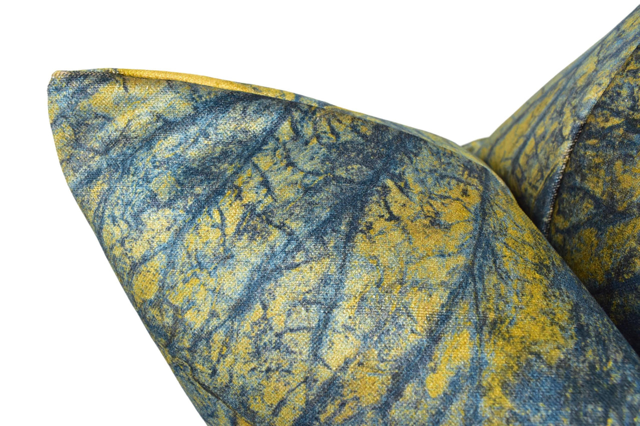 a close up of a blue and yellow pillow