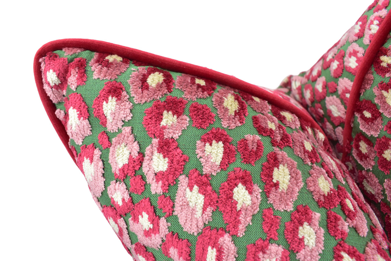 a close up of a red and green pillow