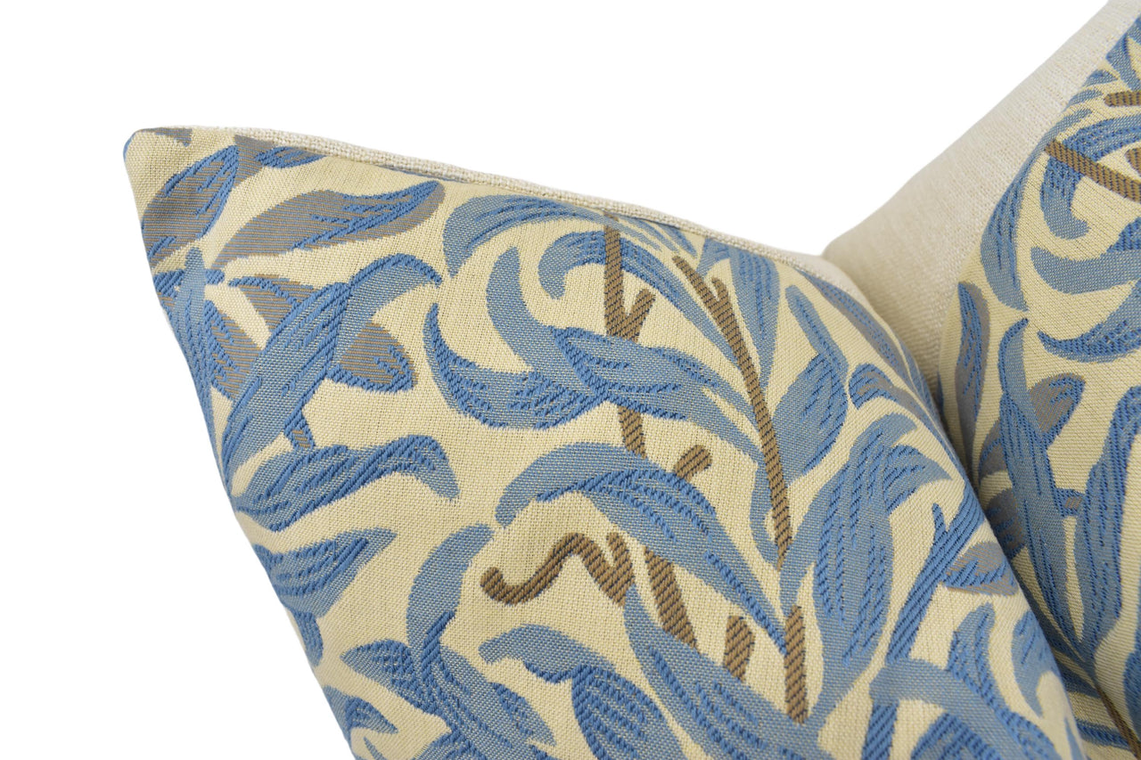 a close up of a blue and beige pillow