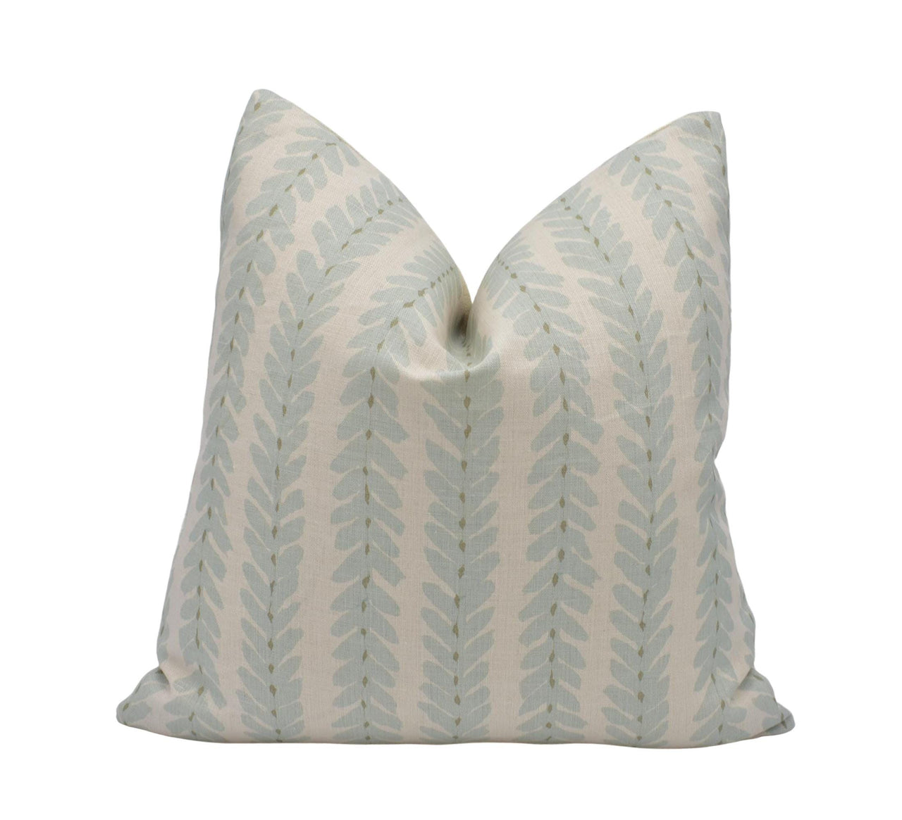 a white and blue pillow with a leaf pattern