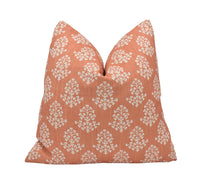 Thumbnail for an orange pillow with white flowers on it