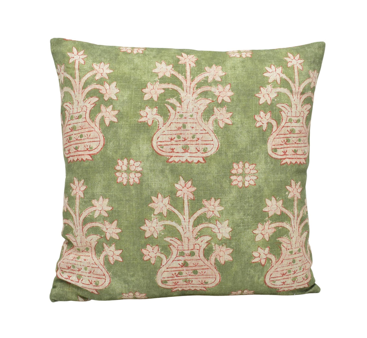 a green pillow with pink and white flowers on it