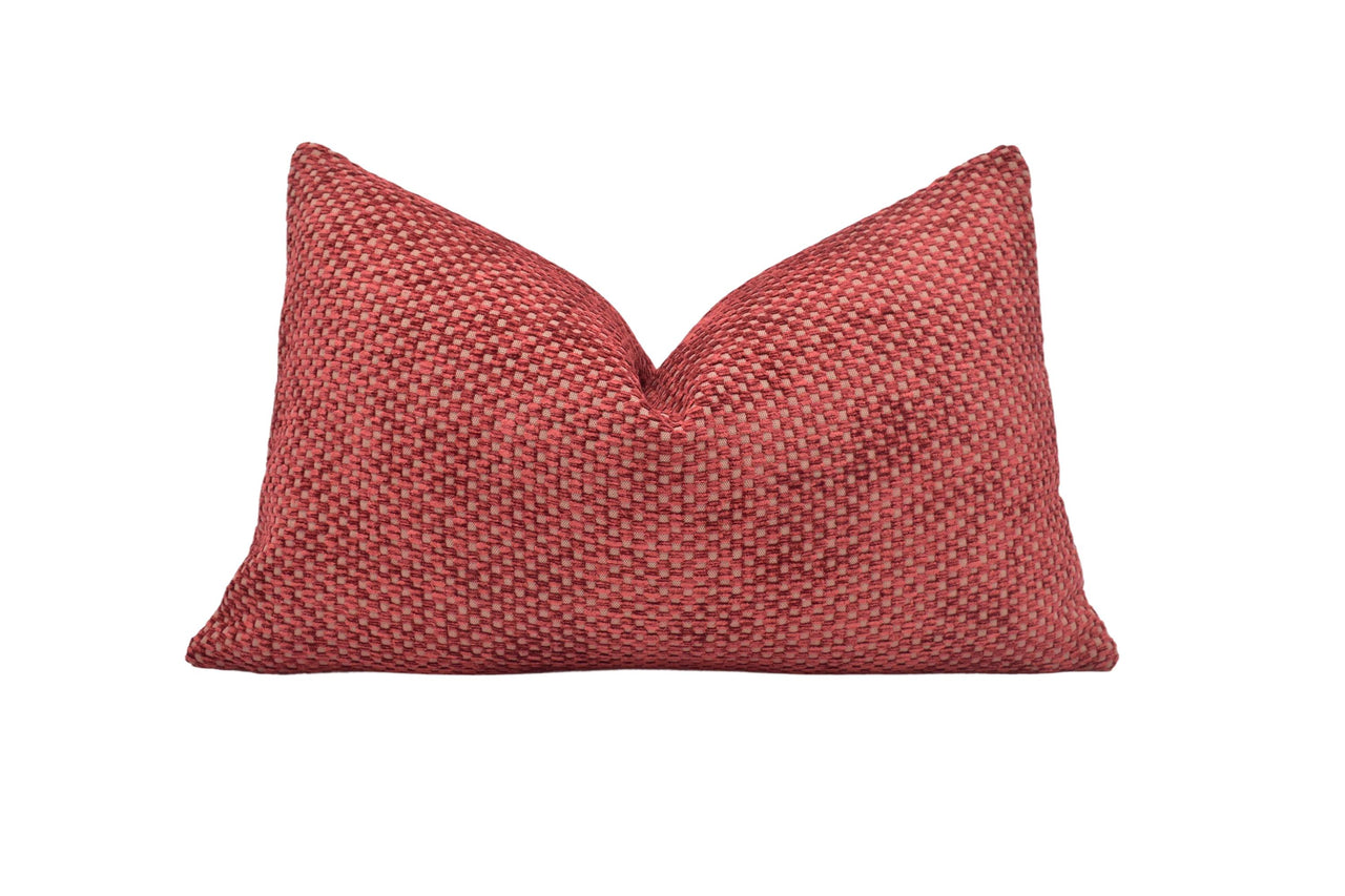 a red pillow on a white background