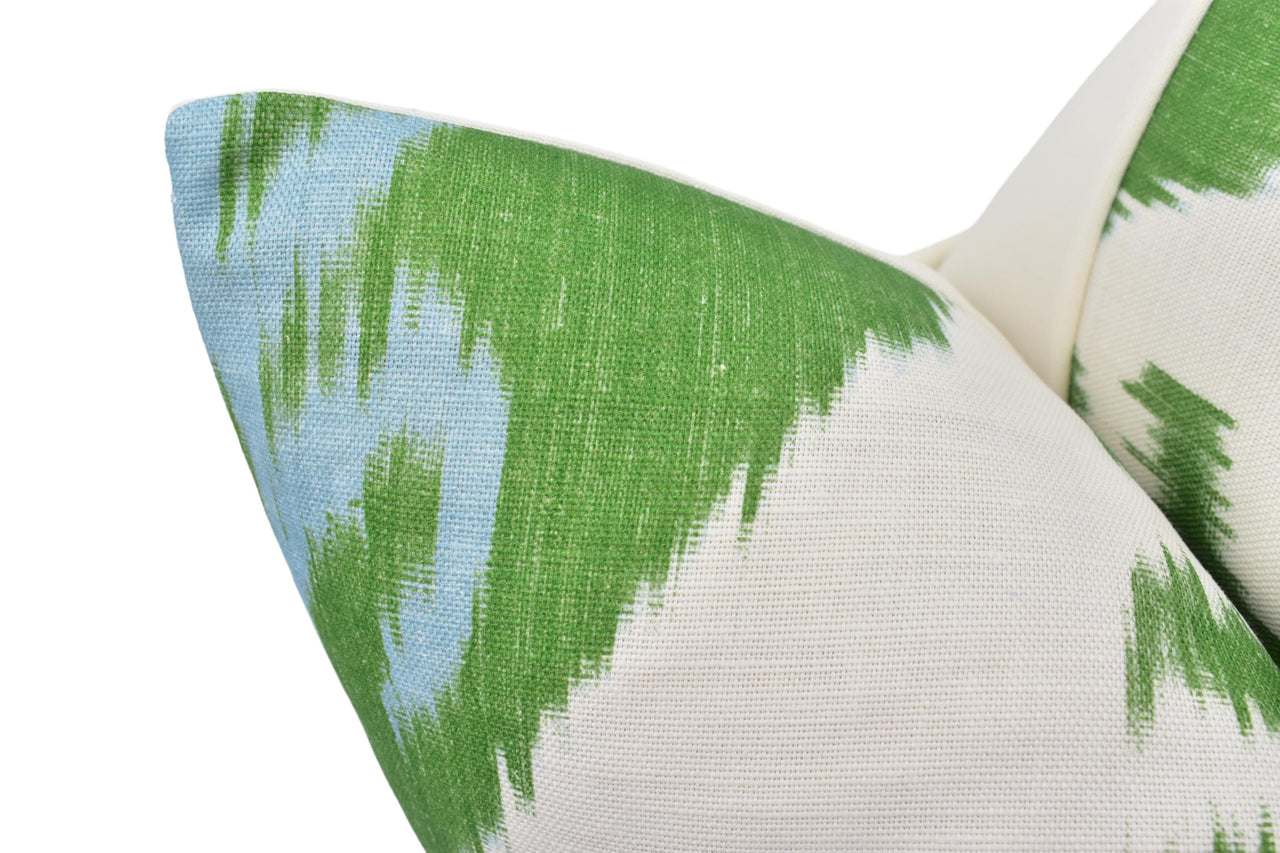 a close up of a green and white pillow