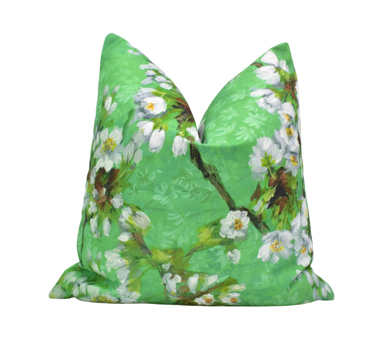 a green pillow with white flowers on it