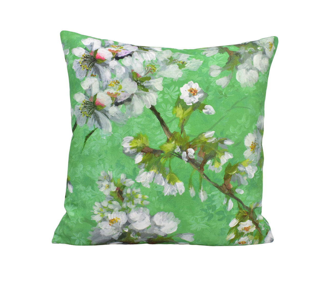 a green pillow with white flowers on it