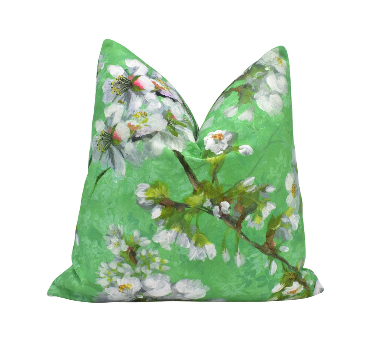 a green pillow with white flowers on it