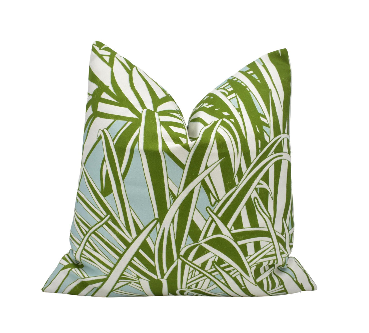 a green and white pillow on a white background