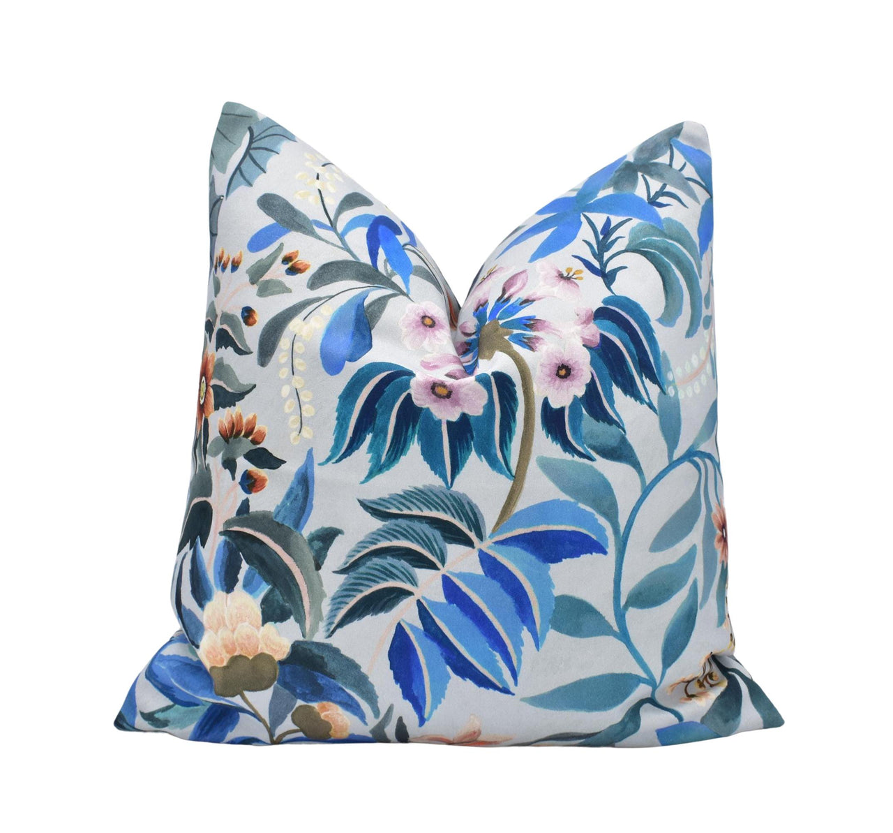 a blue and white pillow with flowers on it